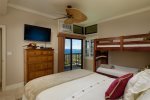 One of the bedroom features a queen bed, bunk beds, flat screen TV and private lanai